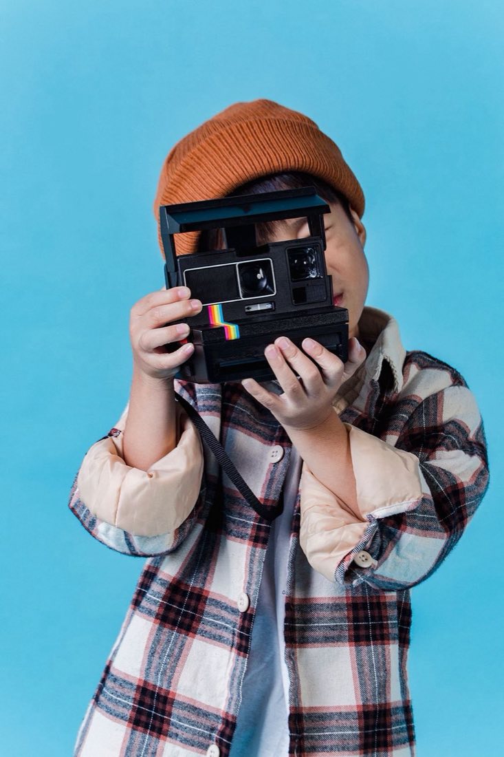 Young photographer taking a picture with a camera