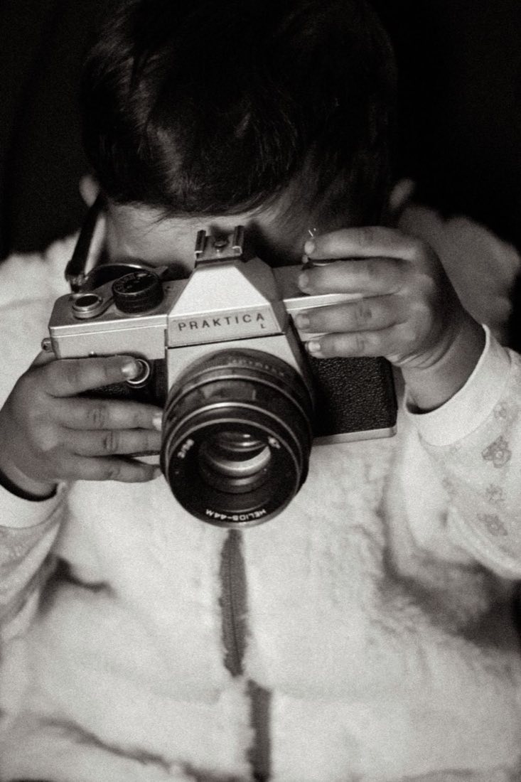 Photographer holding a camera ready to capture a story